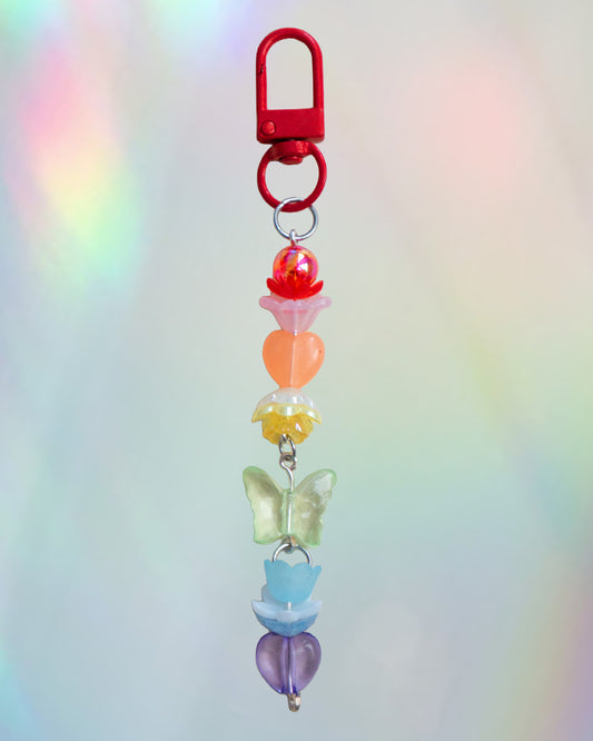 Colorful keychain with rainbow colored beads on an iridescent gradient background