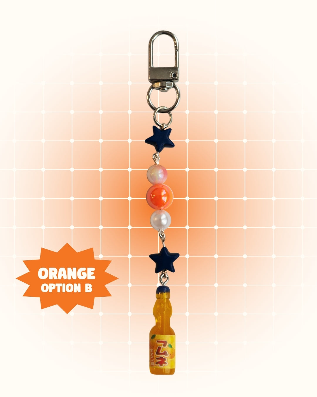 Keychain with orange soda bottle and star charms on an orange gradient background
