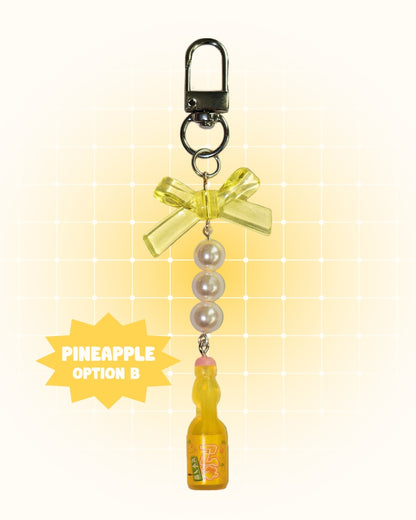 Colorful keychain with pineapple soda design on a yellow gradient background
