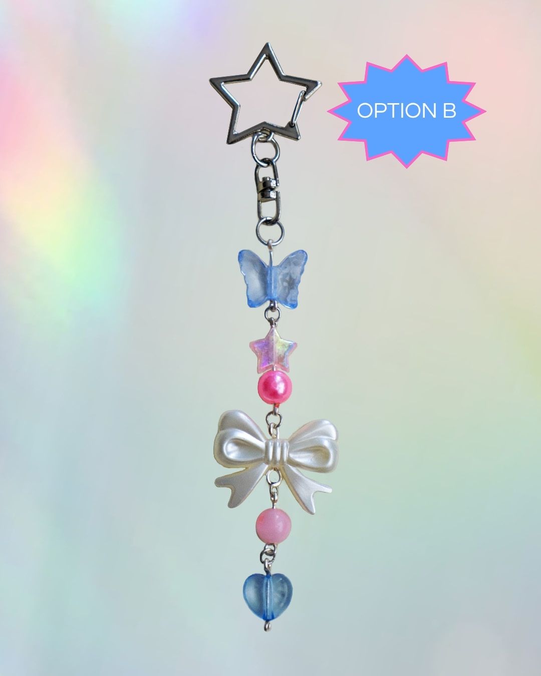 Trans flag themed keychain with blue, pink, and white beads and silver clasp