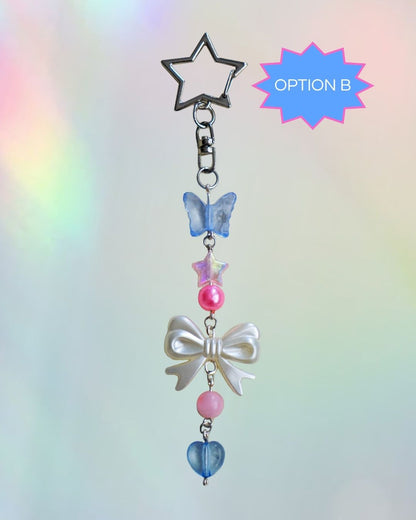Trans flag themed keychain with blue, pink, and white beads and silver clasp